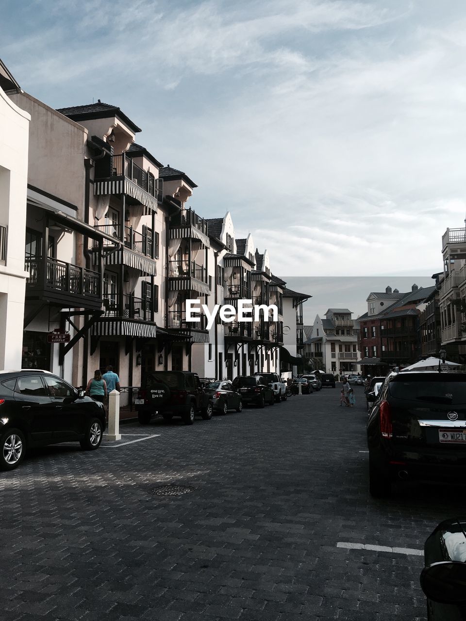 Cars on road against sky in city