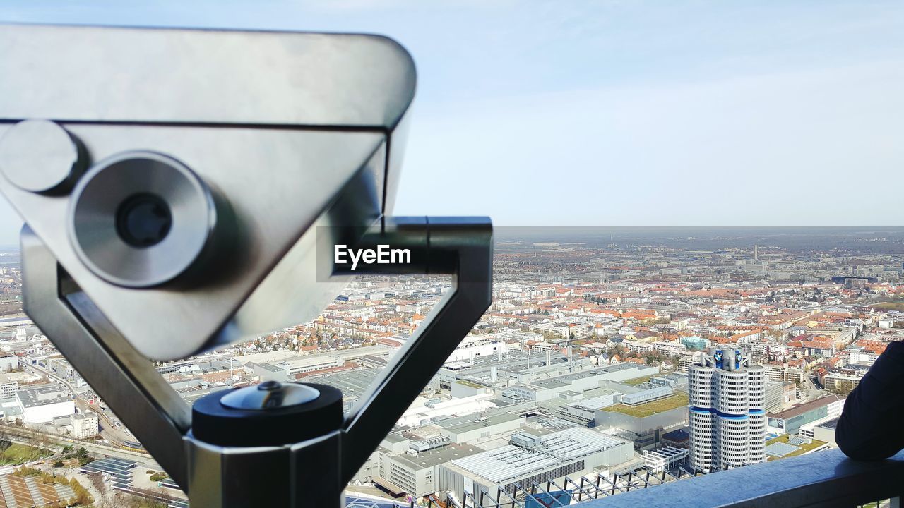 Coin-operated binoculars overlooking cityscape