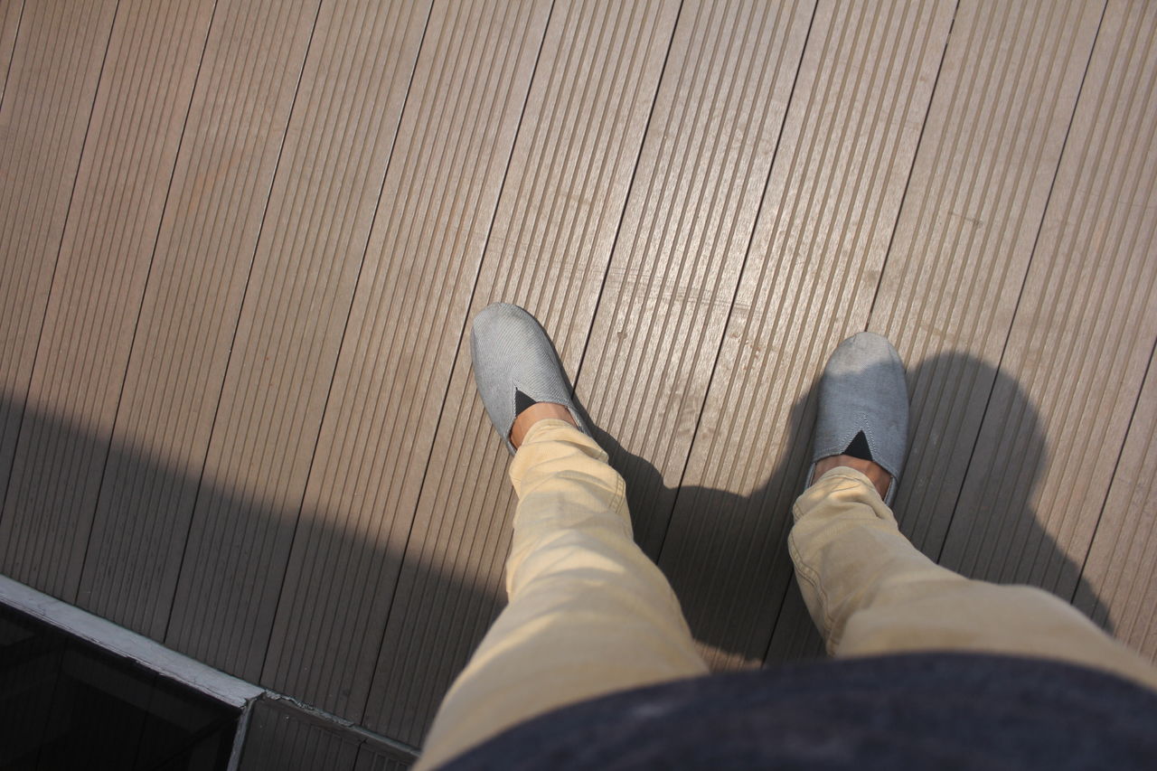 Low section of man standing on floor