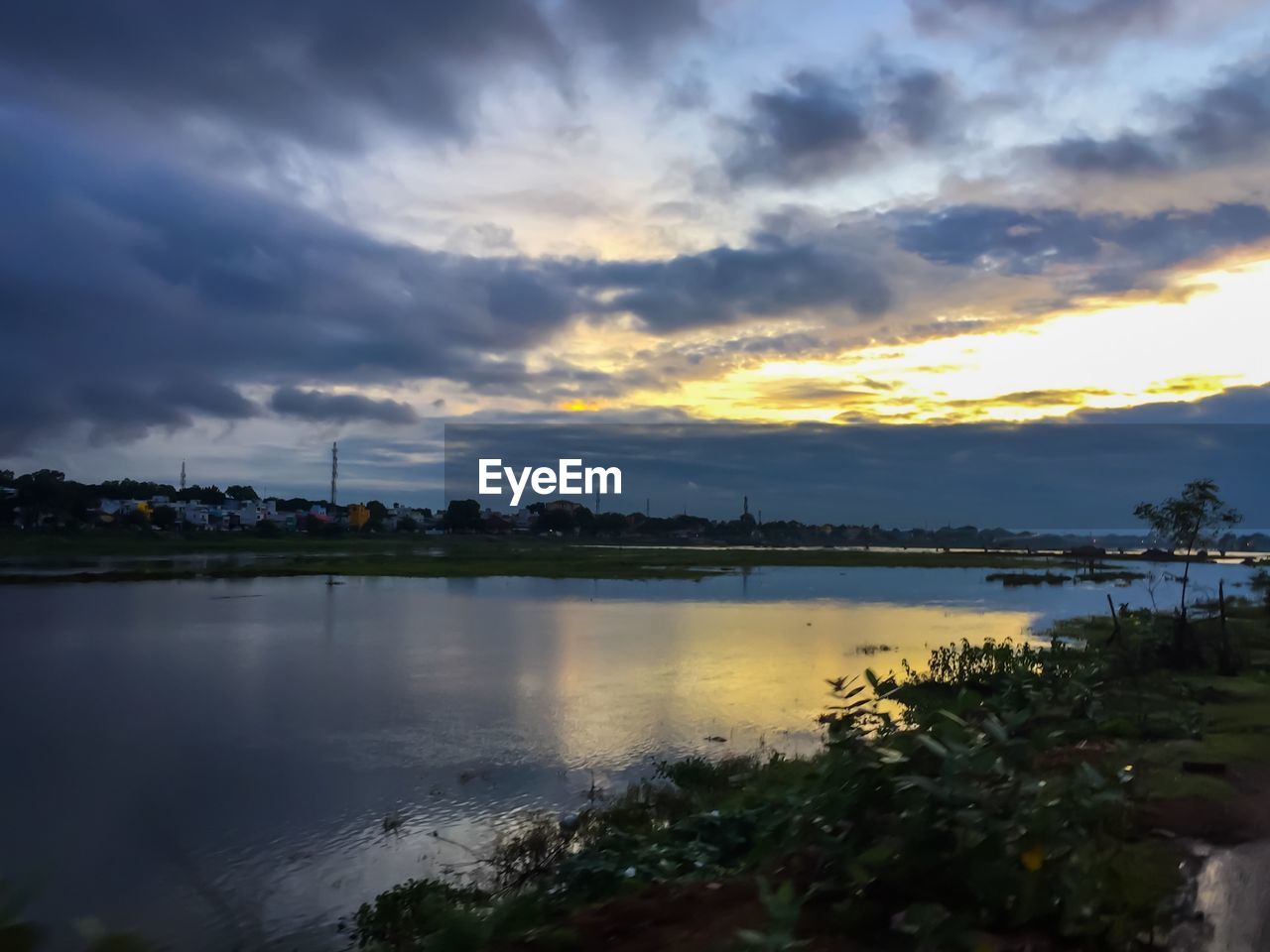 SCENIC VIEW OF LAKE AT SUNSET