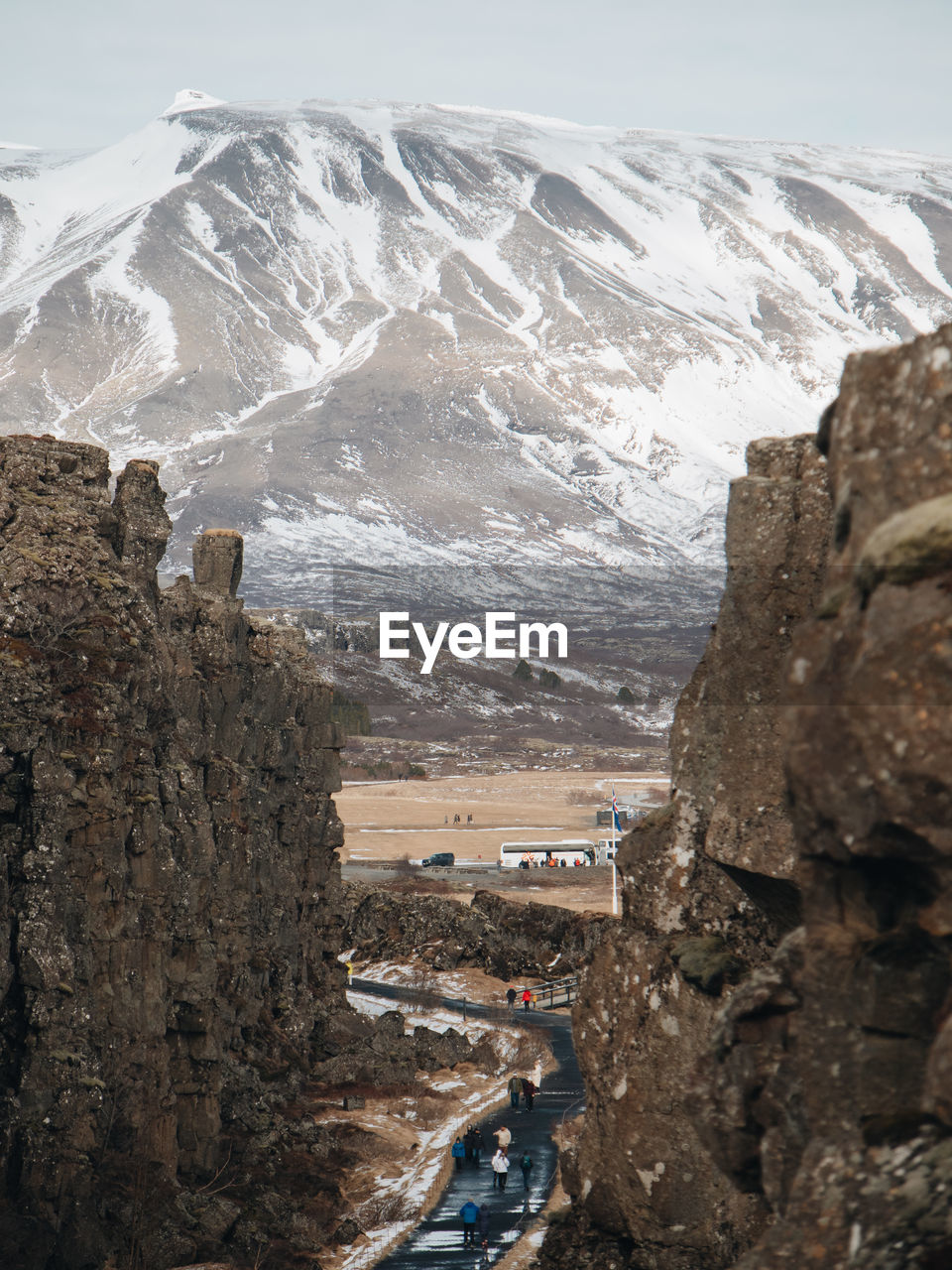 high angle view of townscape by snowcapped mountains against sky