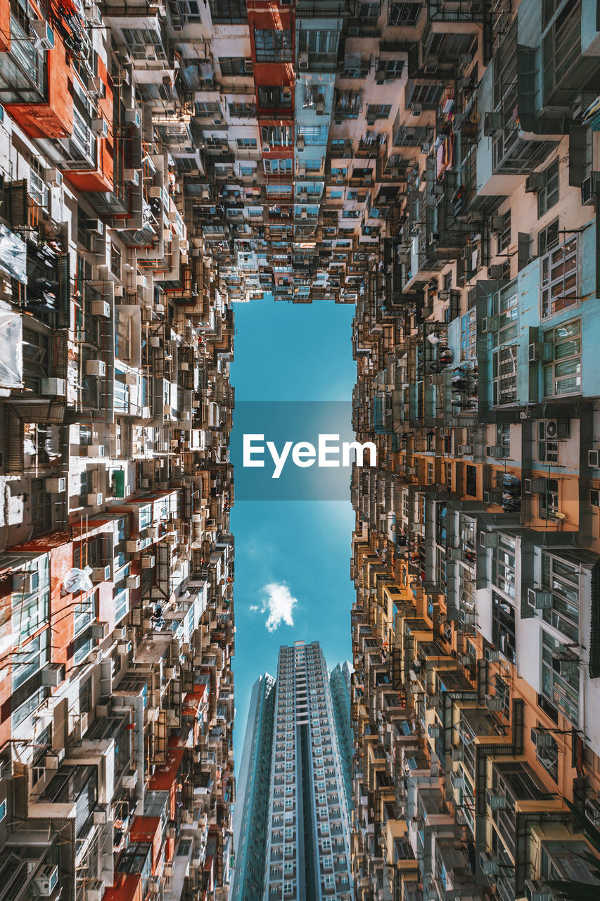 DIRECTLY BELOW SHOT OF BUILDINGS AGAINST SKY