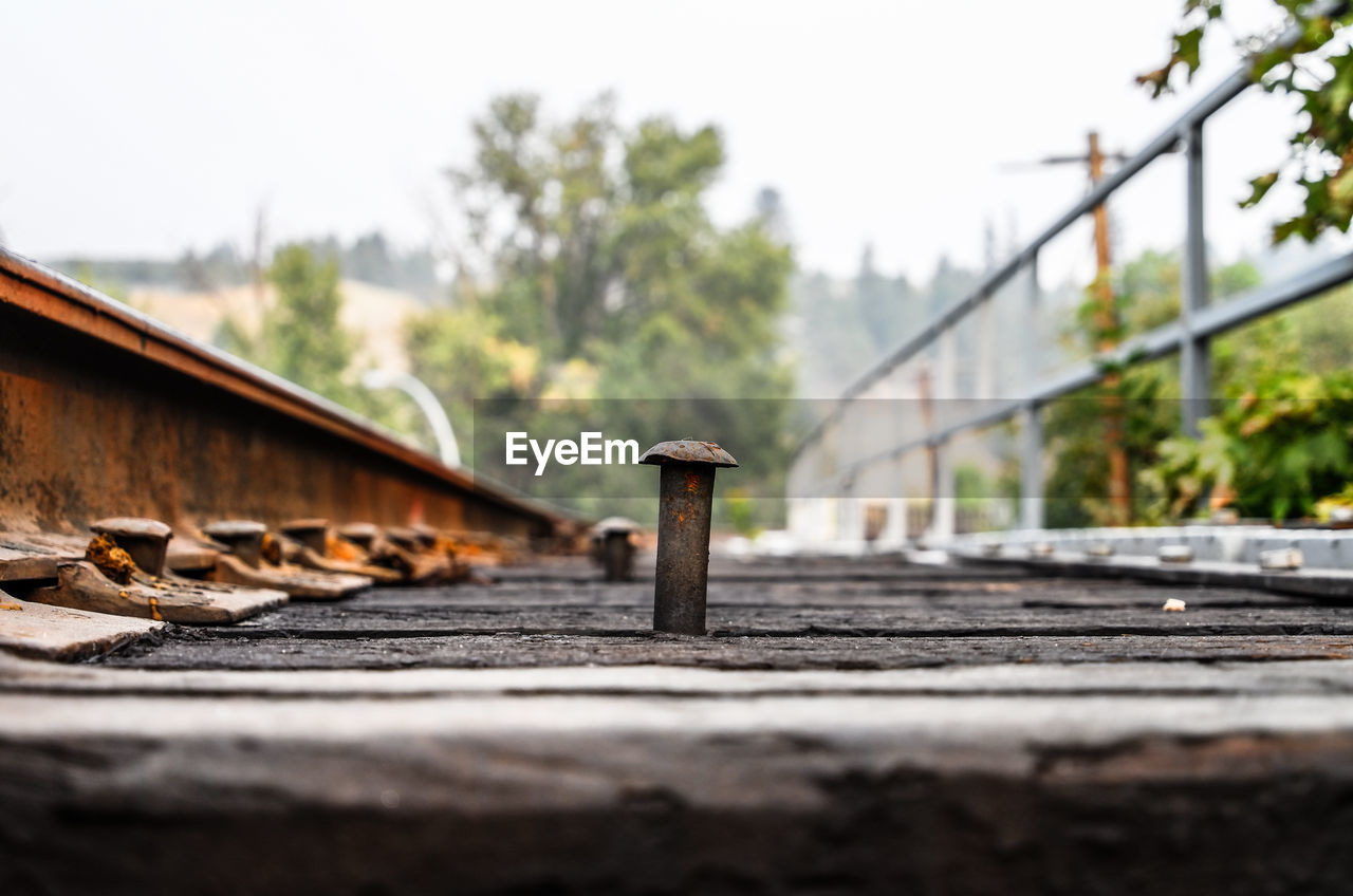 Close-up of rusty railroad track against clear sky