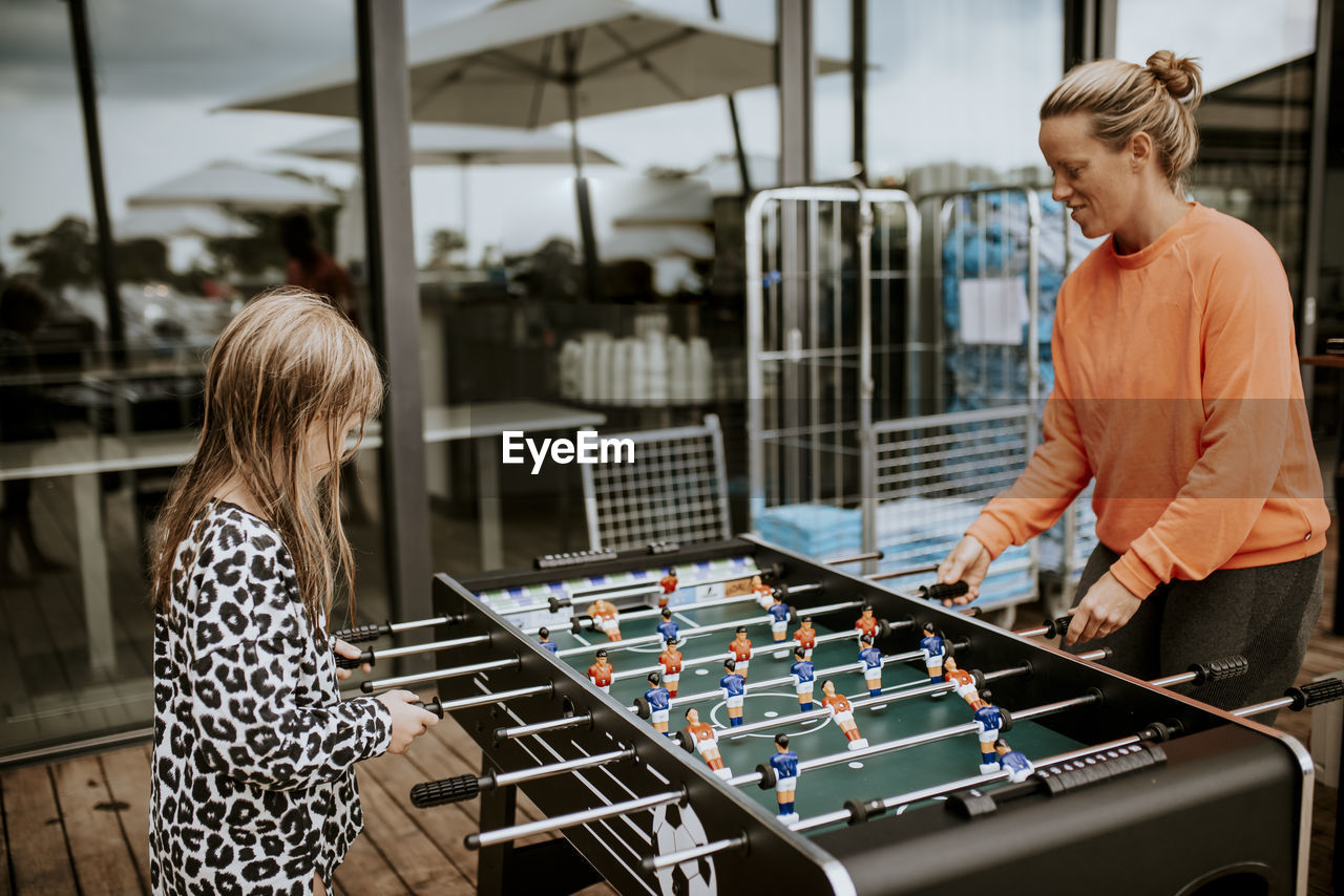 Mother and daughter playing foosball