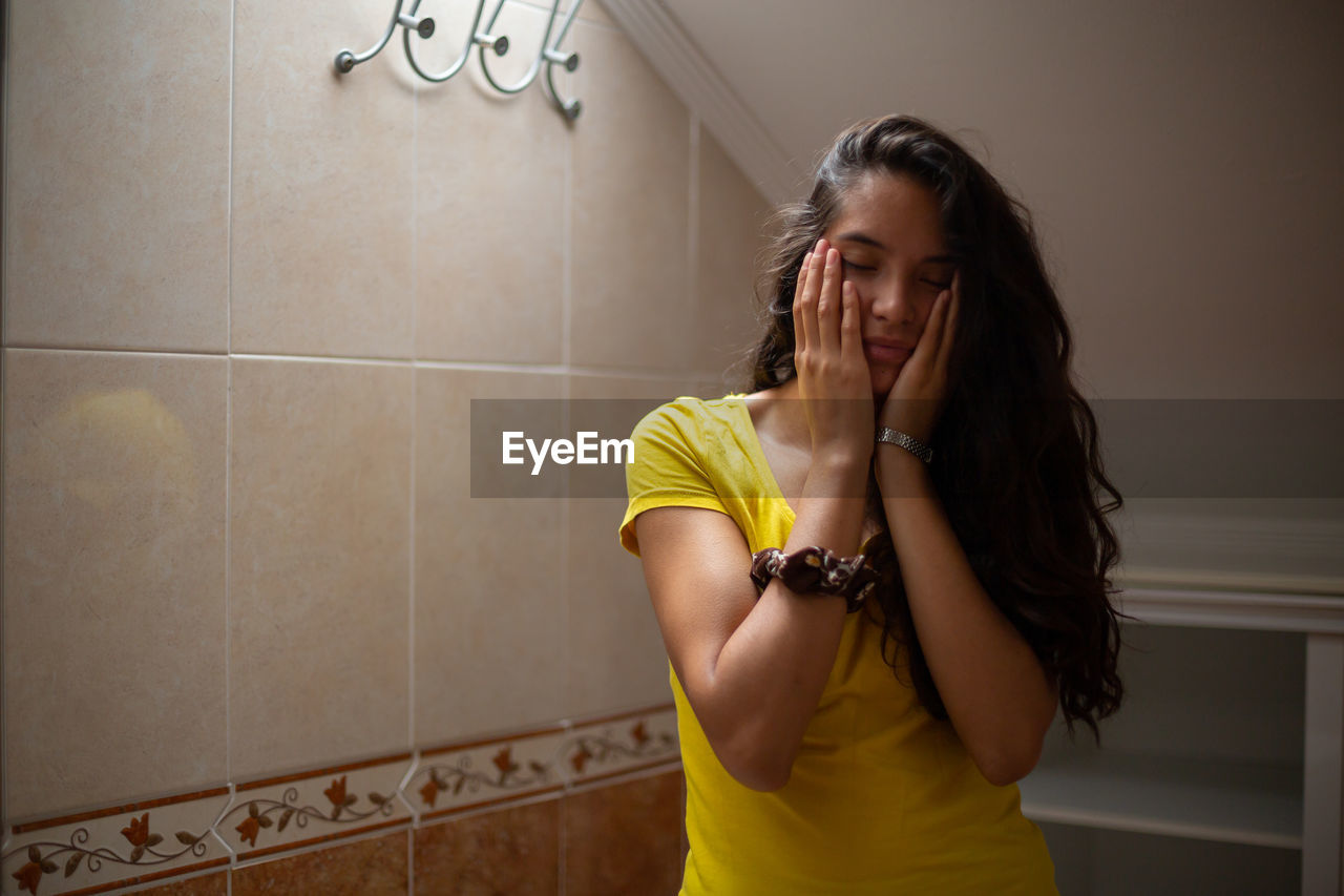 Tired woman covering face with hands
