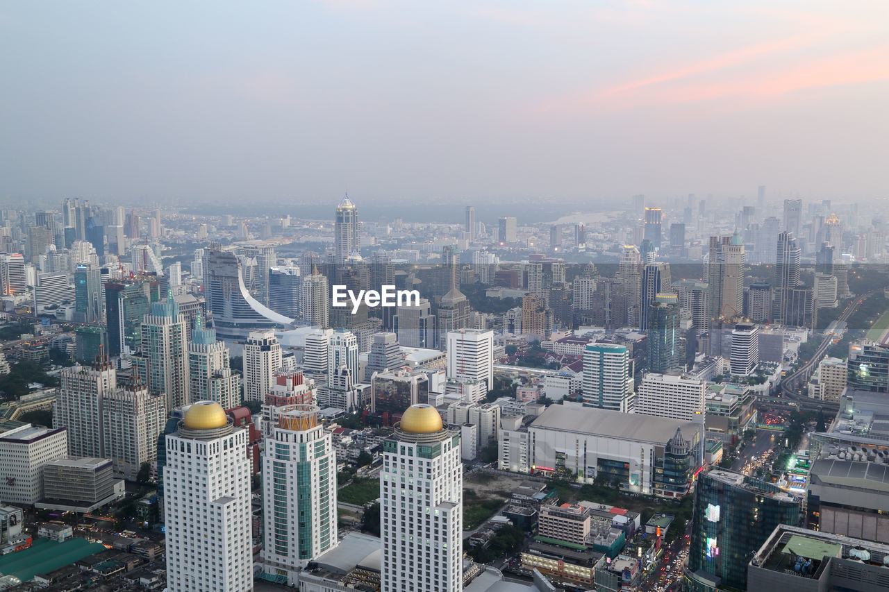 High angle view of modern buildings in city against sky