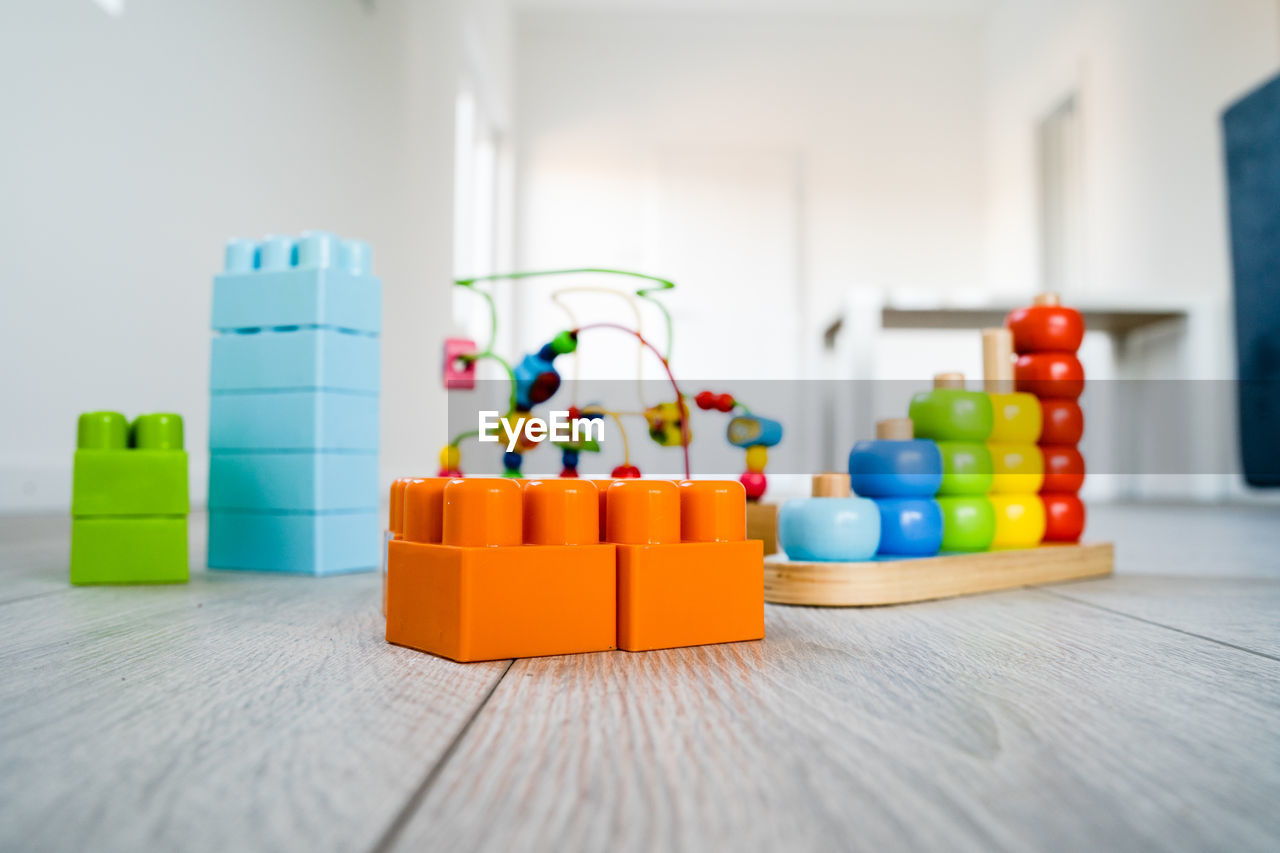 CLOSE-UP OF TOY TOYS ON TABLE AT HOME