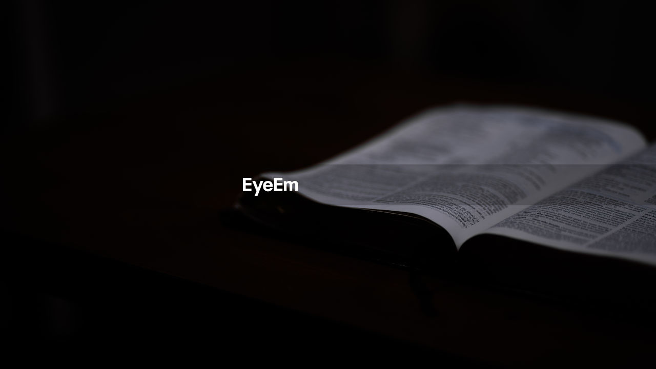book, publication, black, white, indoors, black background, open, paper, page, no people, reading, dark, darkness, copy space, text, education, close-up, studio shot, newspaper, literature, single object, religion, wisdom