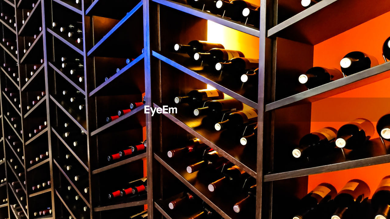Full frame shot of wine bottles on shelf