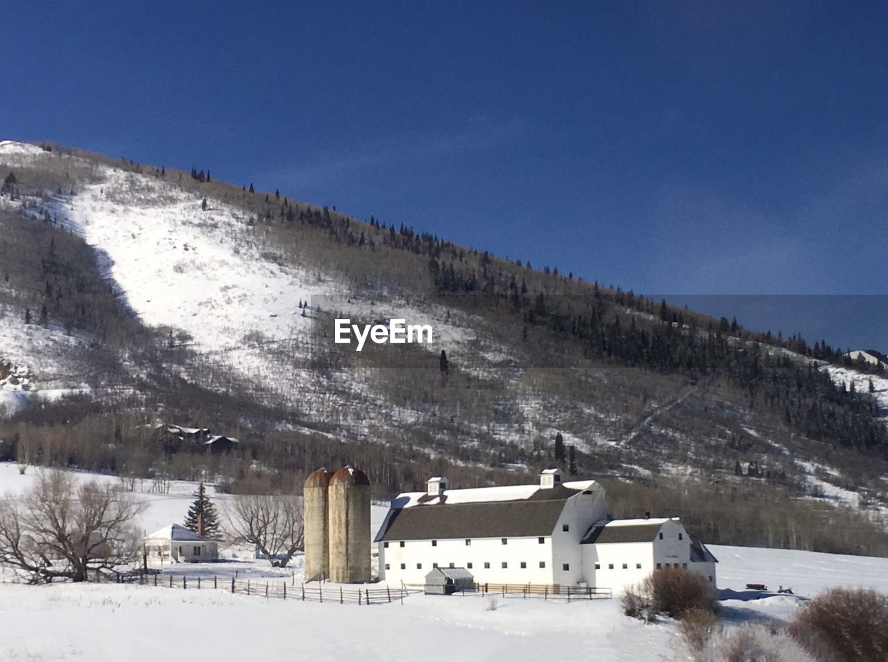 HOUSES ON SNOW AGAINST SKY