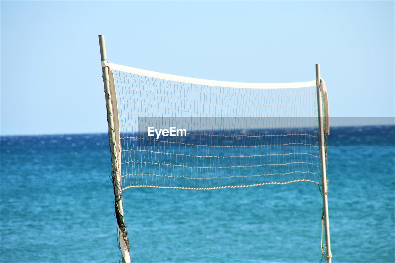 View of net in sea against clear sky