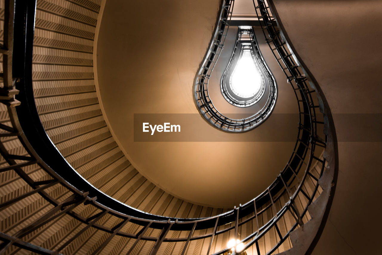 Directly below shot of spiral staircases in building