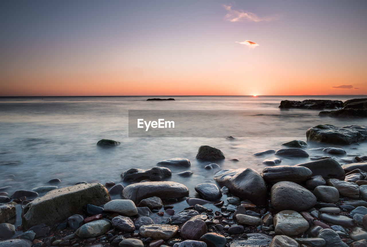 SCENIC VIEW OF SEA AT SUNSET