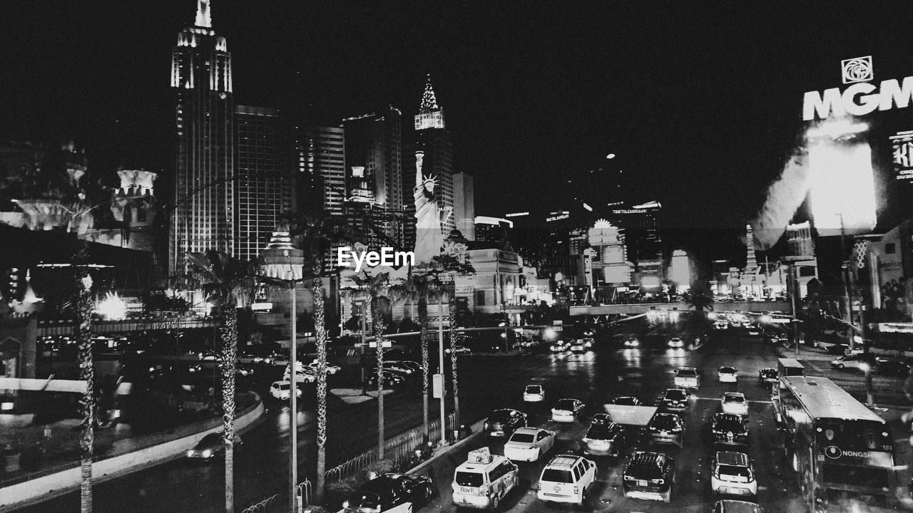 PANORAMIC VIEW OF CITY STREET AND BUILDINGS AT NIGHT