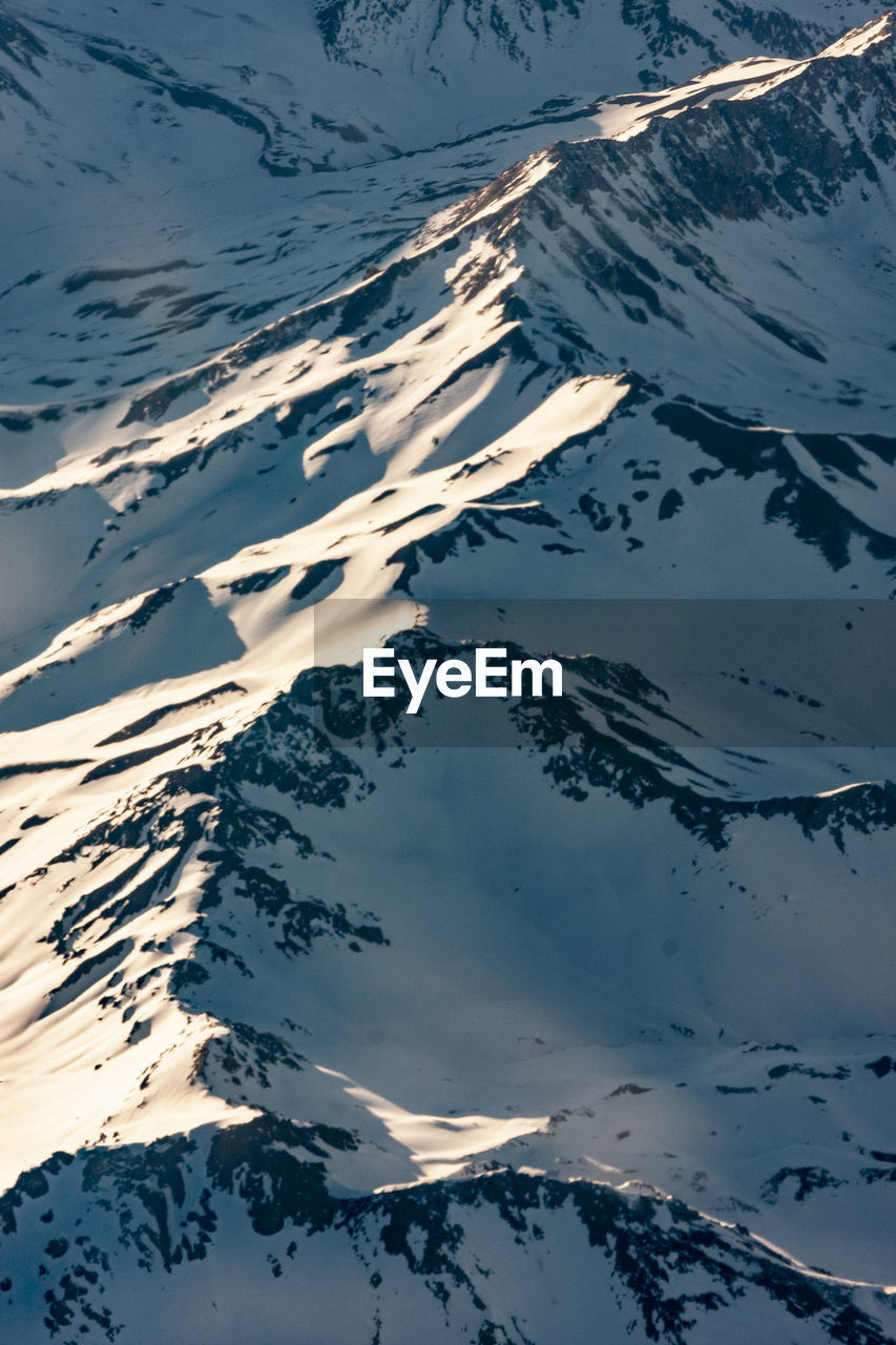 High angle view of snowcapped mountains against sky