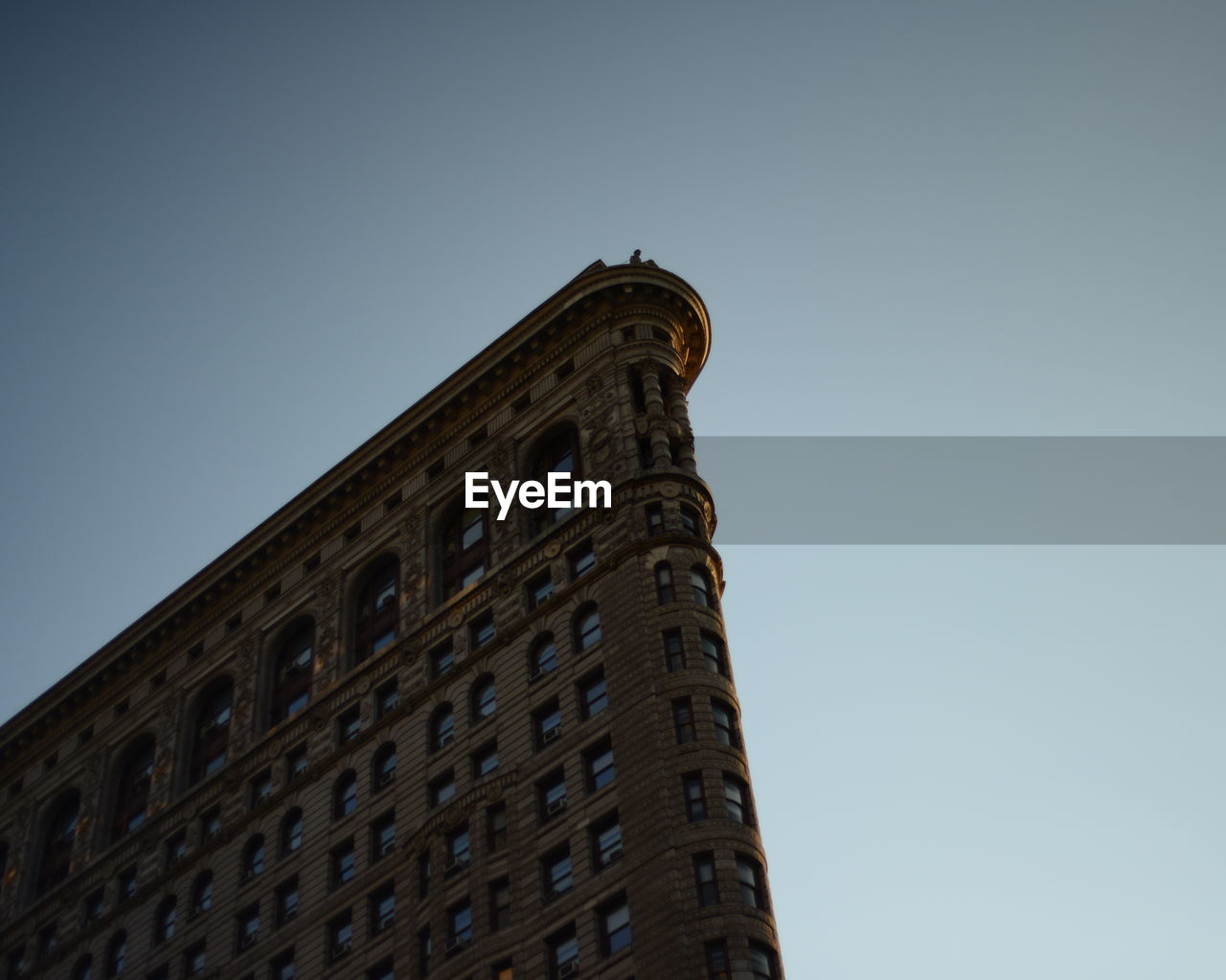 Low angle view of flatiron building against clear sky at manhattan in city