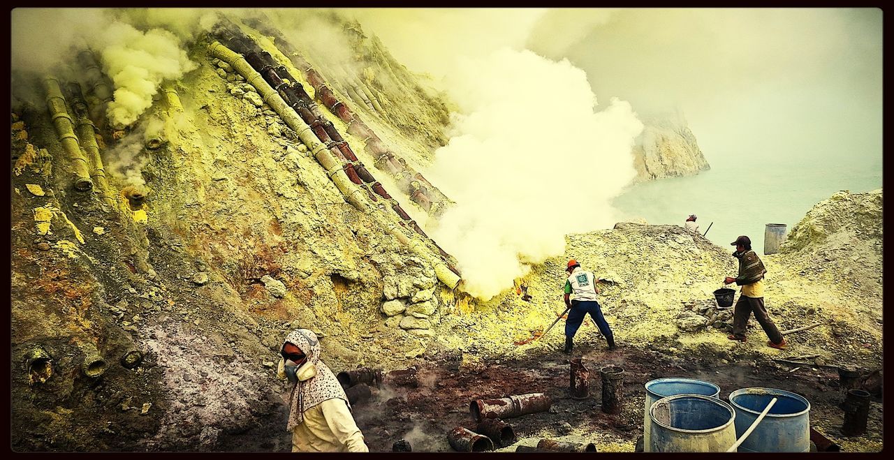 People working on a volcanic mountain