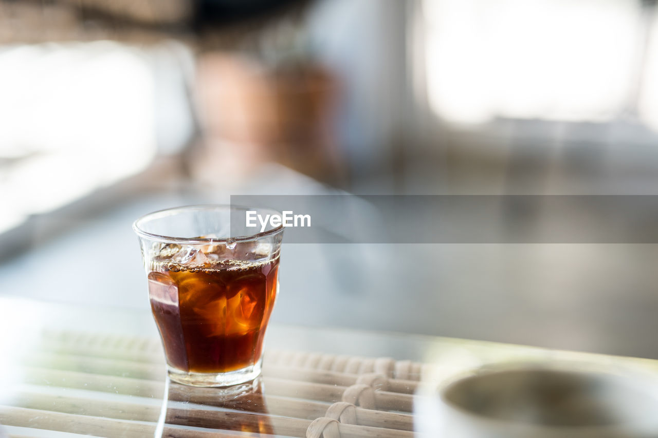 CLOSE-UP OF DRINK ON TABLE