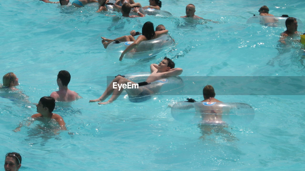 PEOPLE SWIMMING IN WATER