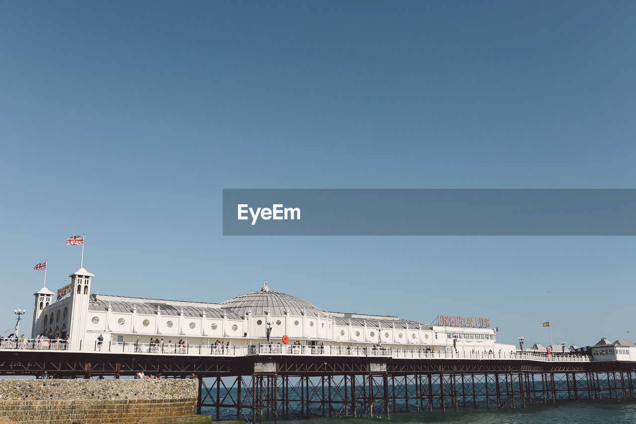 Palace pier over sea against clear sky