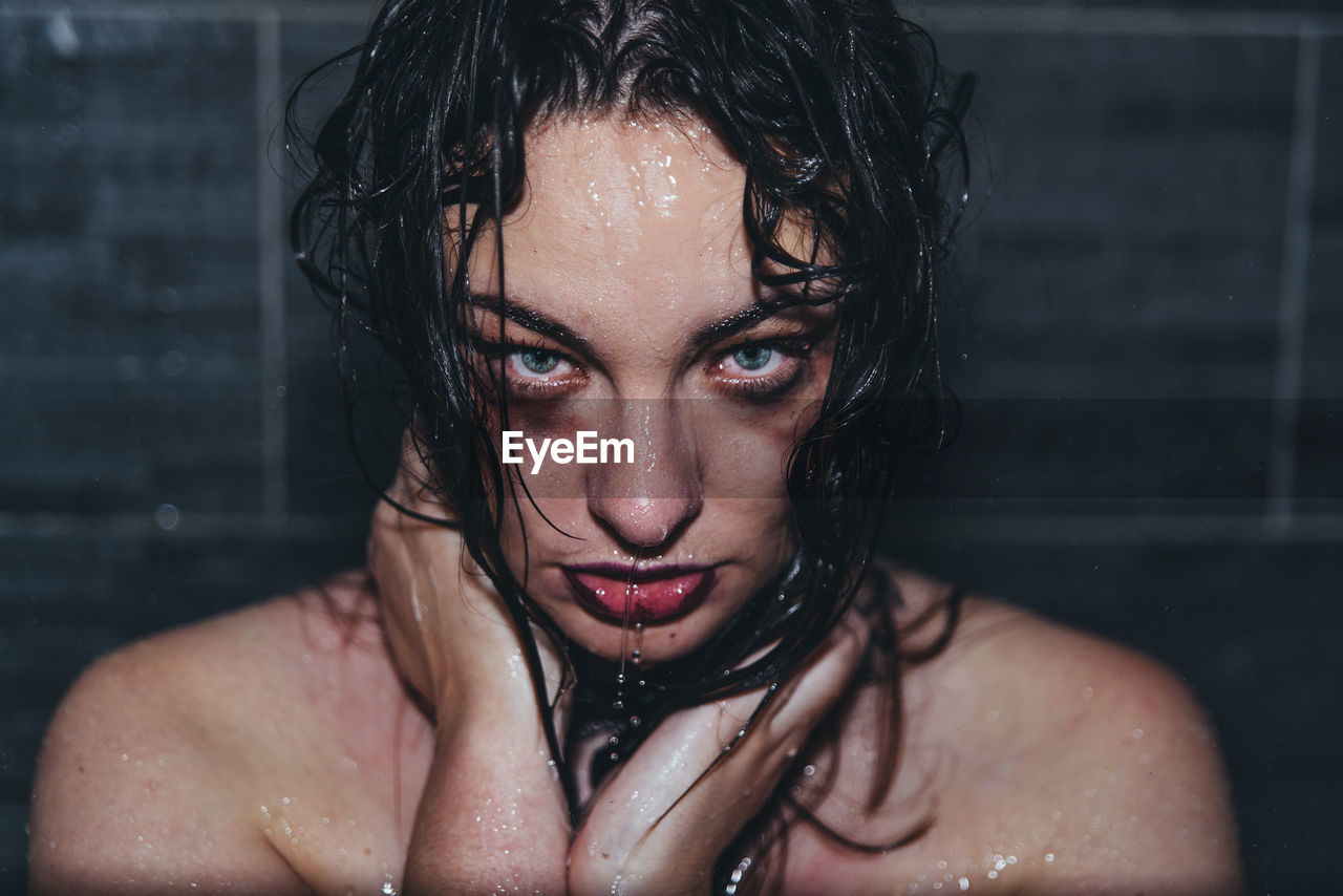 Portrait of beautiful woman with wet hair in bathroom