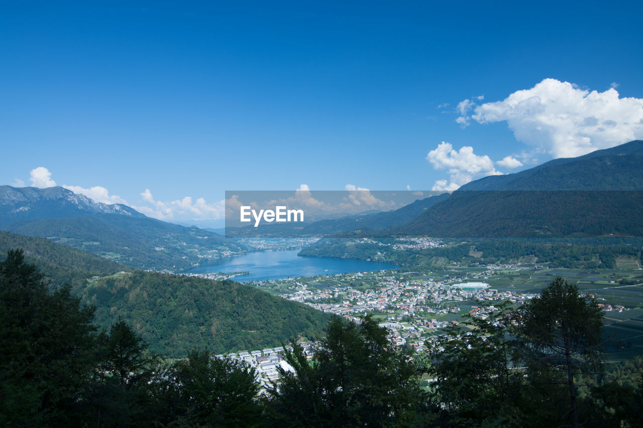 Scenic view of sea and mountains against blue sky