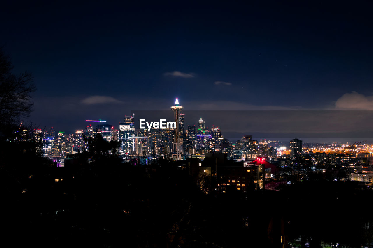 ILLUMINATED BUILDINGS IN CITY AT NIGHT