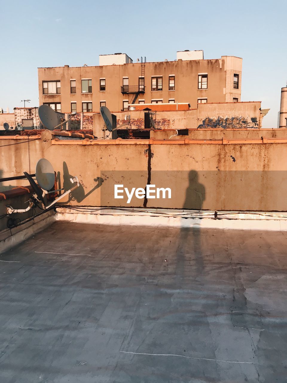 Shadow of man standing on building terrace