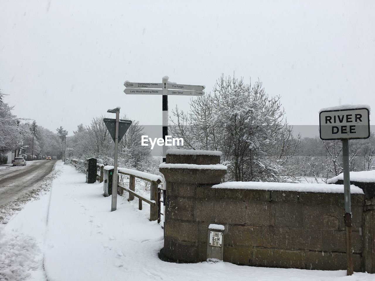 INFORMATION SIGN ON SNOW COVERED TREES