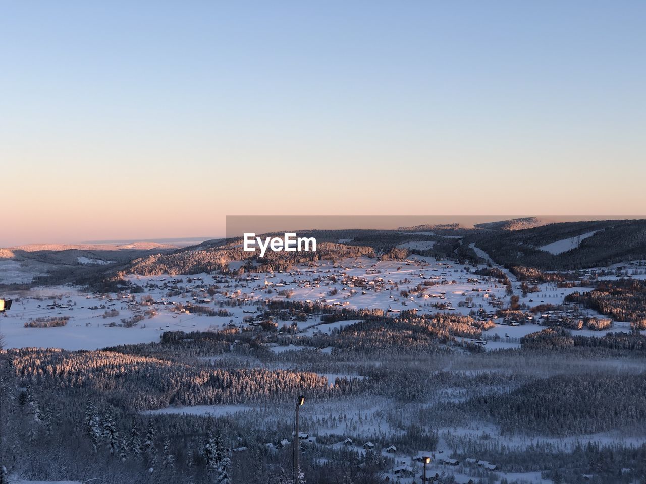 Aerial view of land against clear sky during sunset