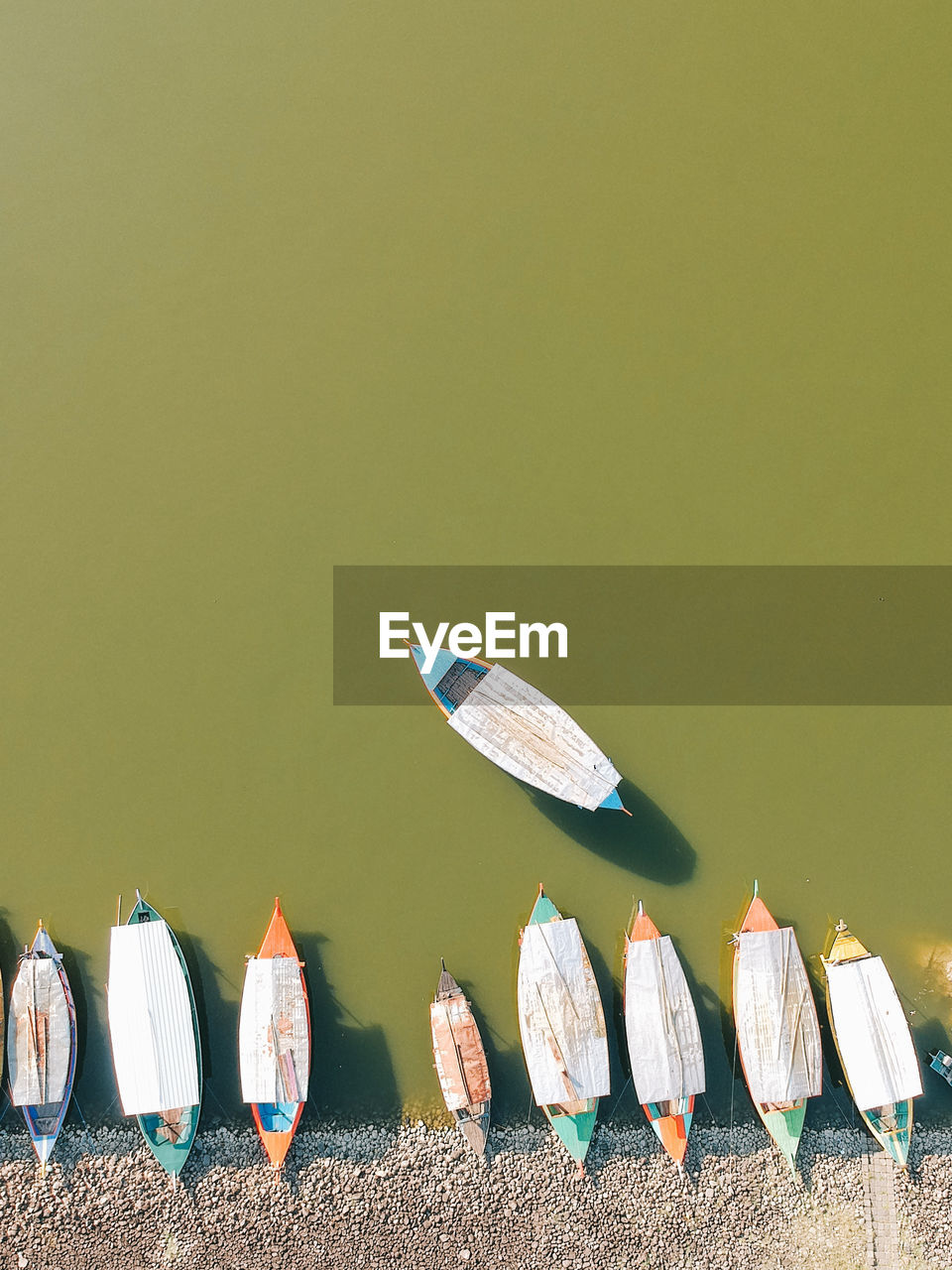 High angle view of colorful boats moored at lakeshore