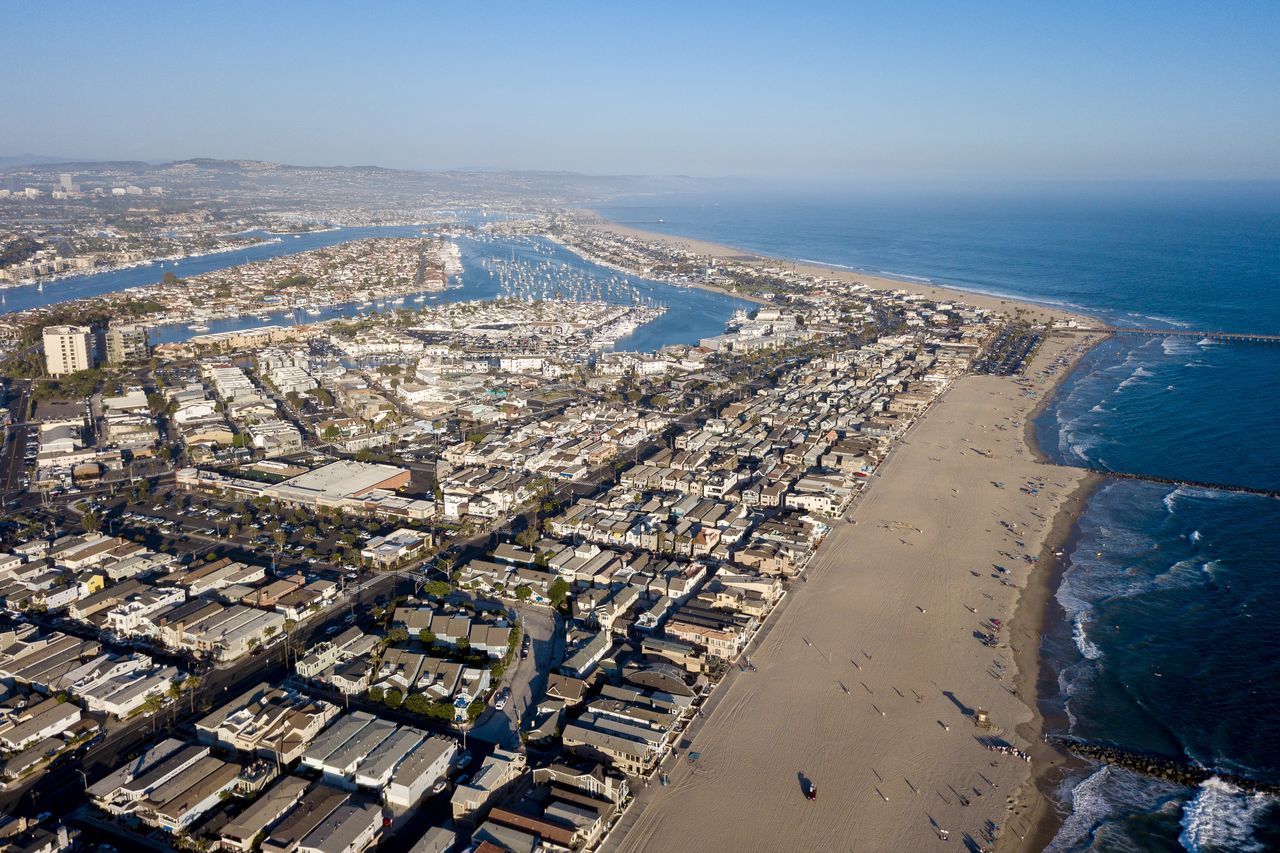 High angle view of sea and cityscape against sky