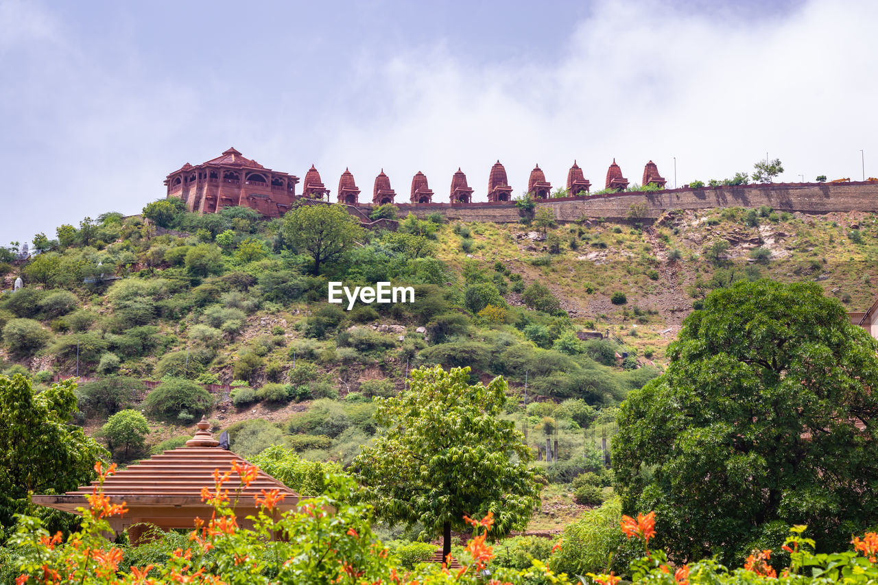 Artistic series or red stone jain temple at mountain top at morning from unique angle