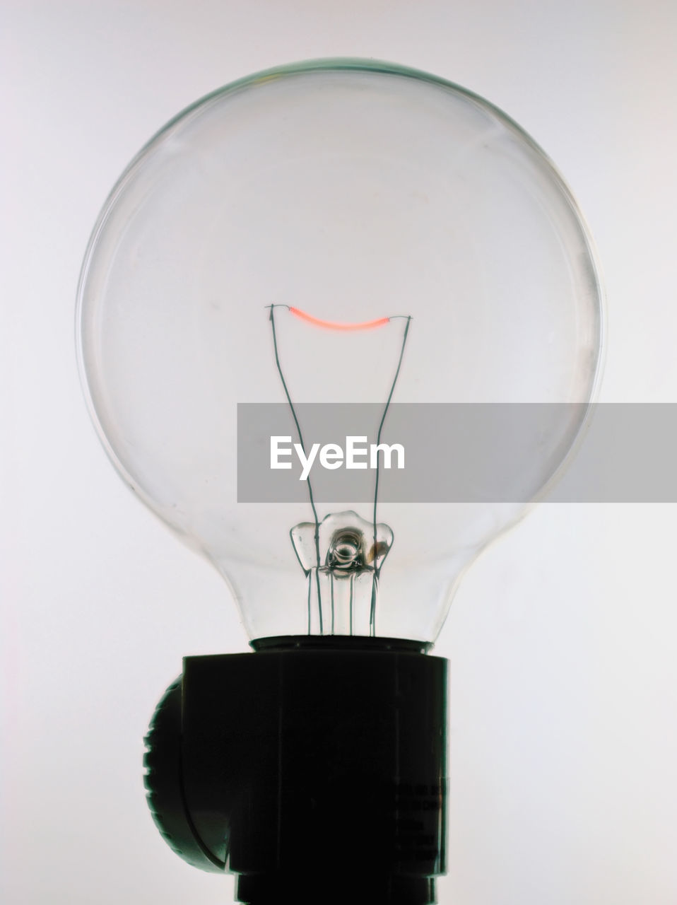 Close-up of light bulb against white background