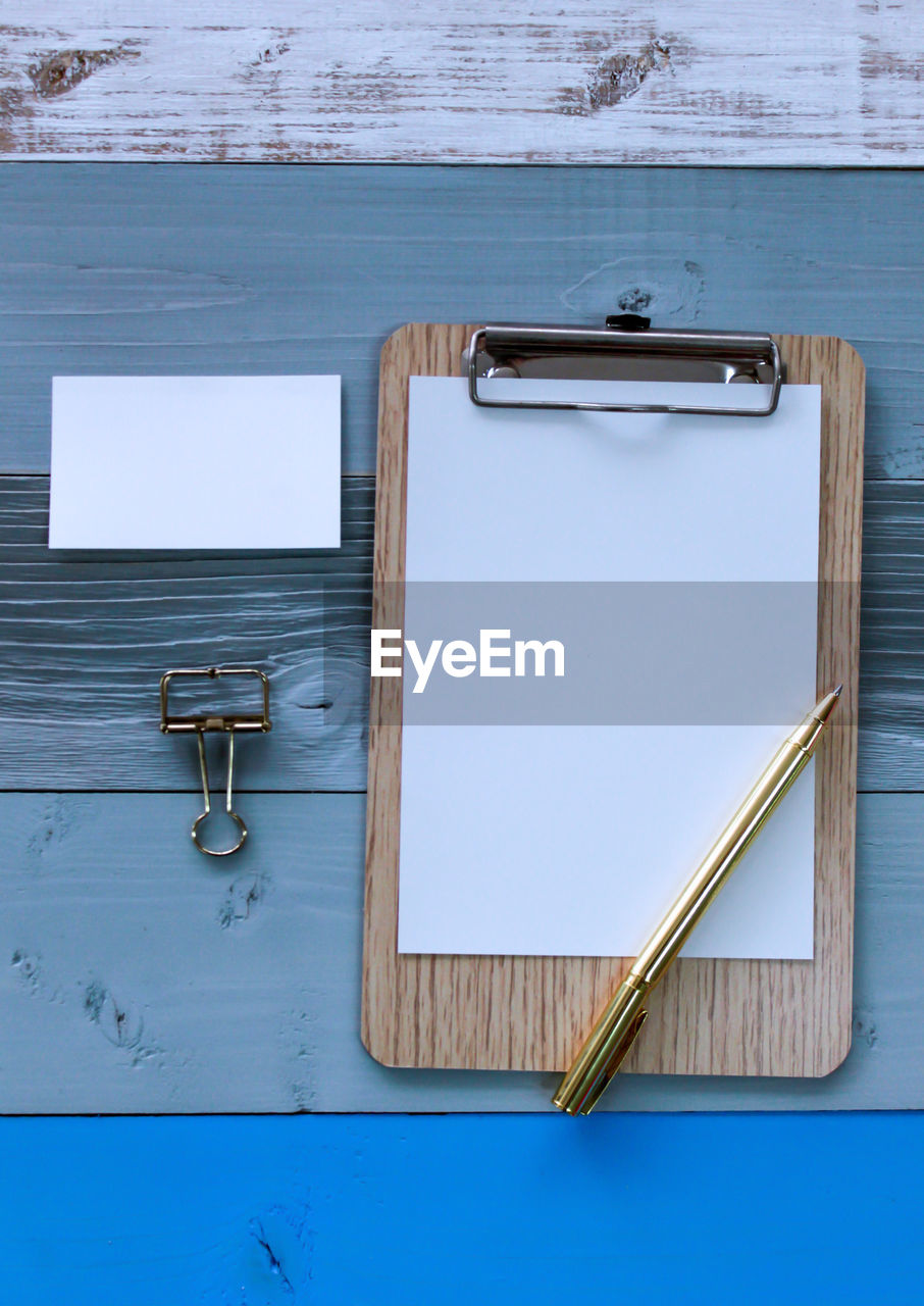 Directly above shot of blank paper in clipboard on table