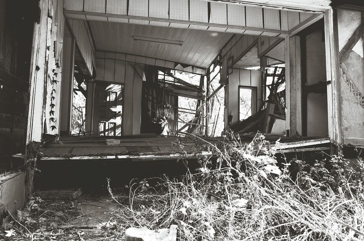 Abandoned broken house with messy area in foreground