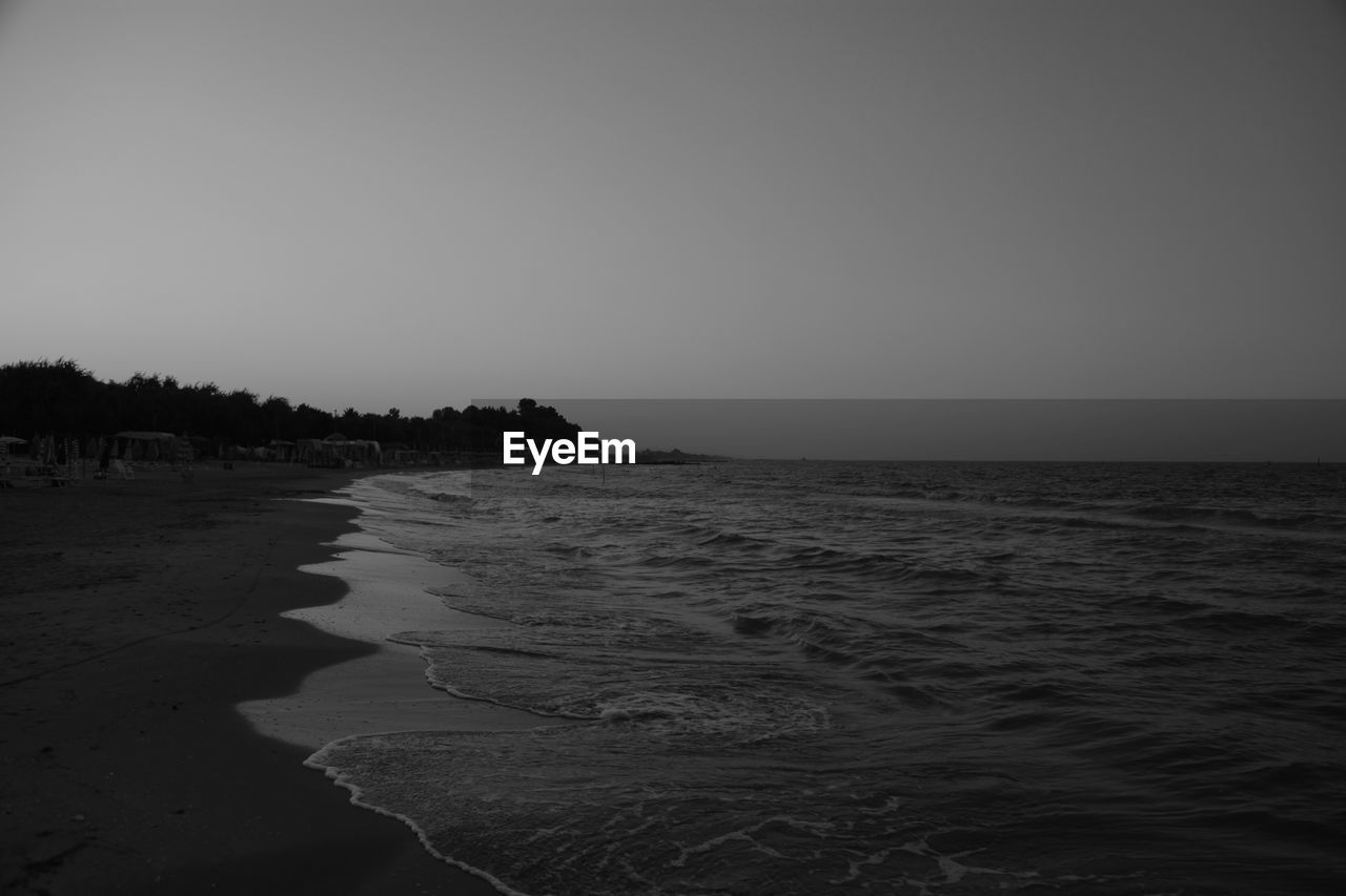 SCENIC VIEW OF BEACH AGAINST CLEAR SKY