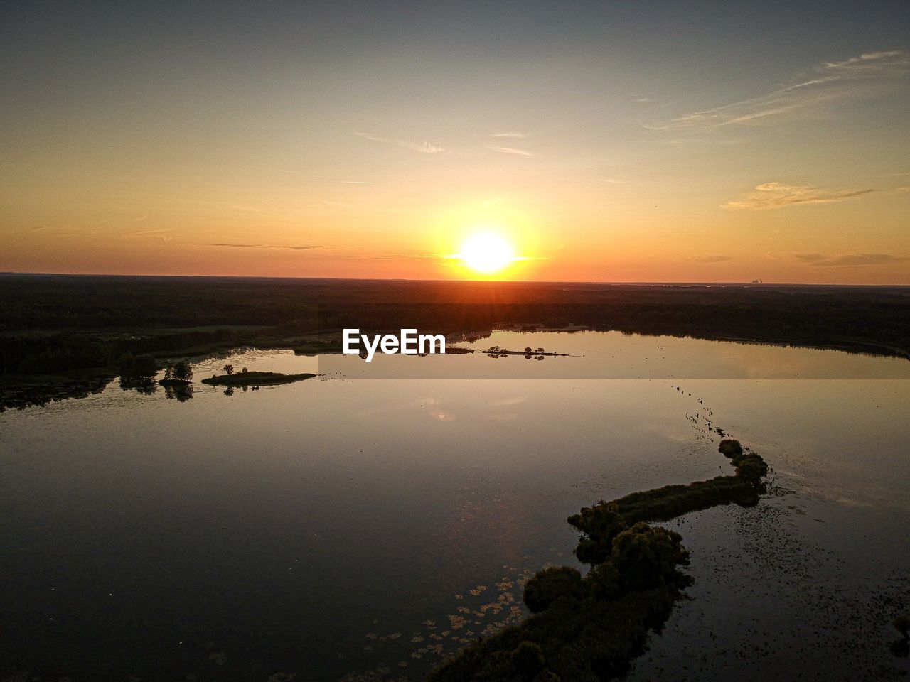 Scenic view of lake against sky during sunset