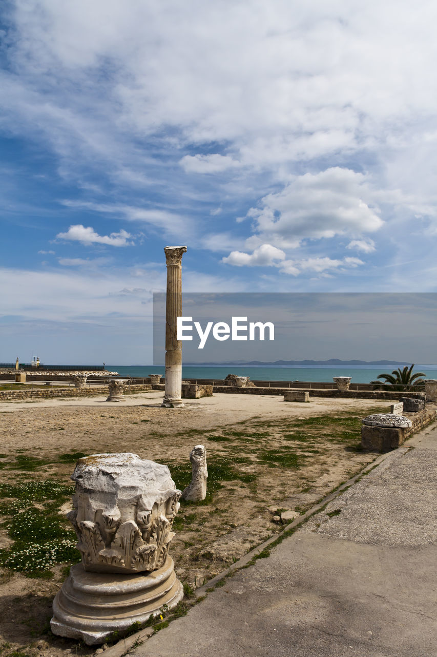 Old ruins at byrsa by mediterranean sea against cloudy sky