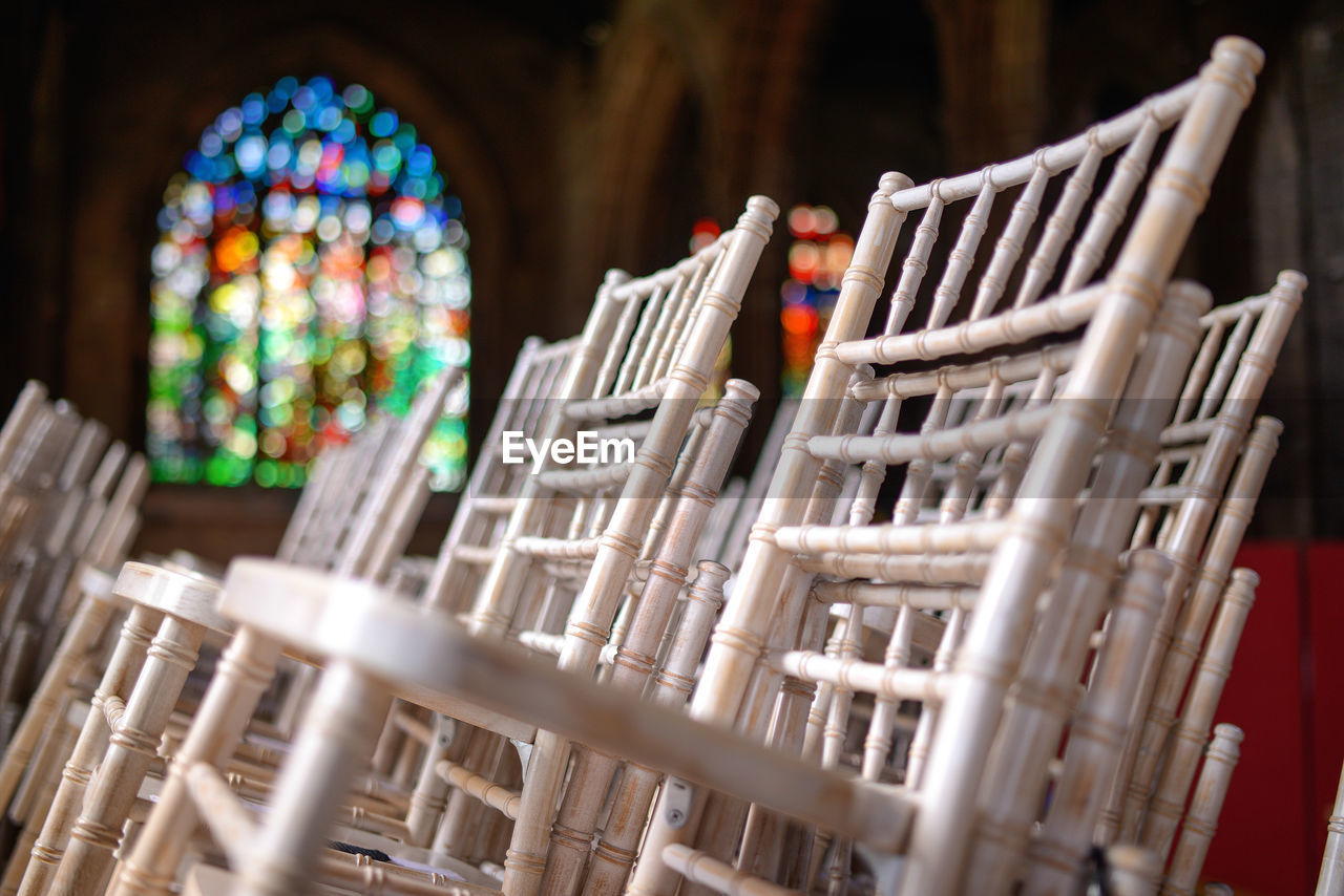 White chairs stacked on each other in a church