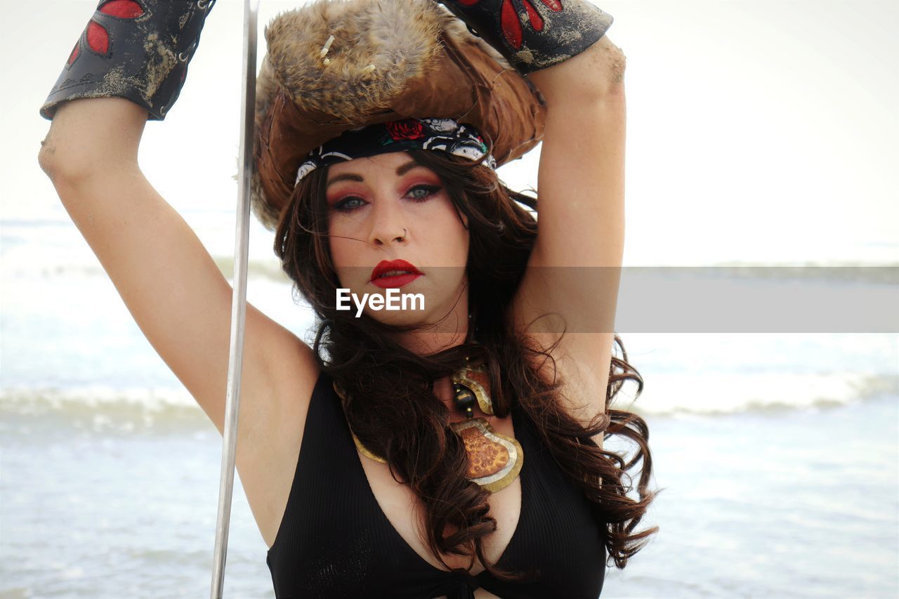 Portrait of woman wearing costume while standing at beach