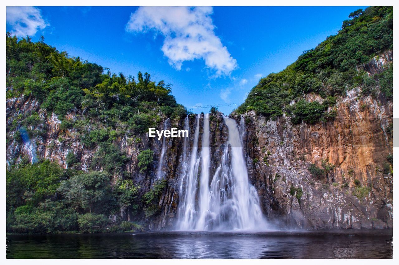 SCENIC VIEW OF WATERFALL IN FOREST