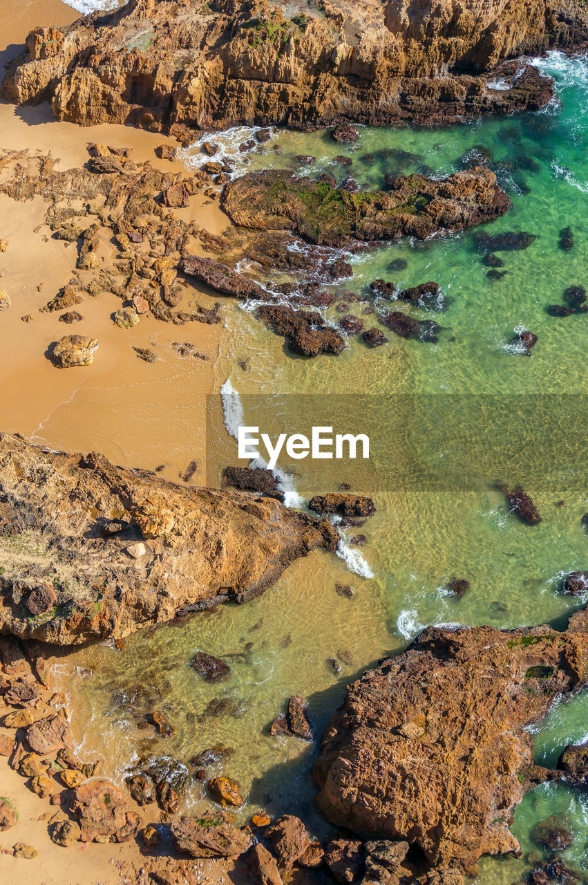 High angle view of rocks in sea