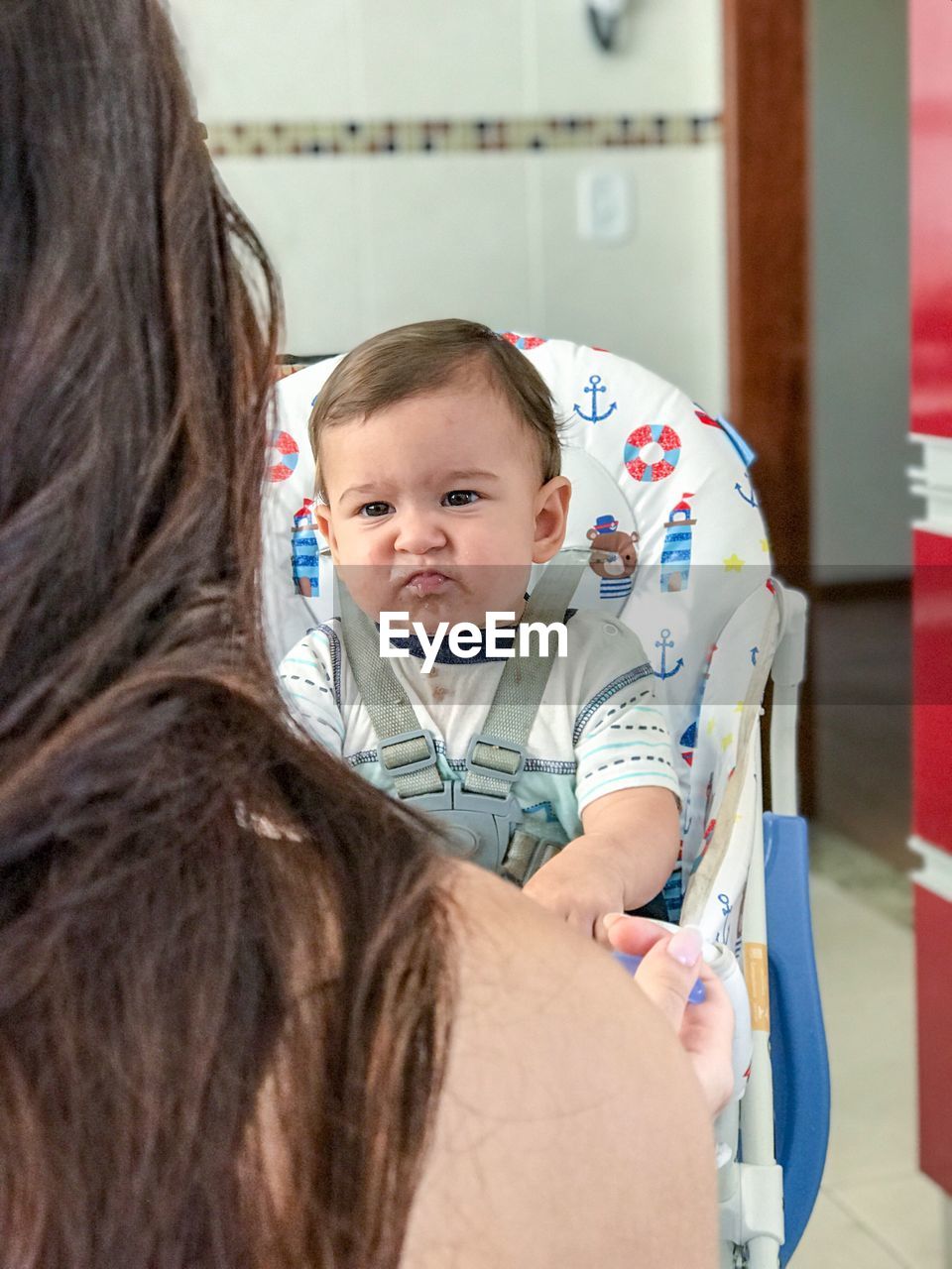 CLOSE-UP OF MOTHER HOLDING BABY WITH DAUGHTER