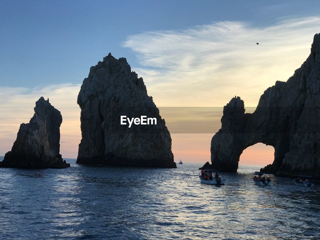 Rock formations in sea against sky