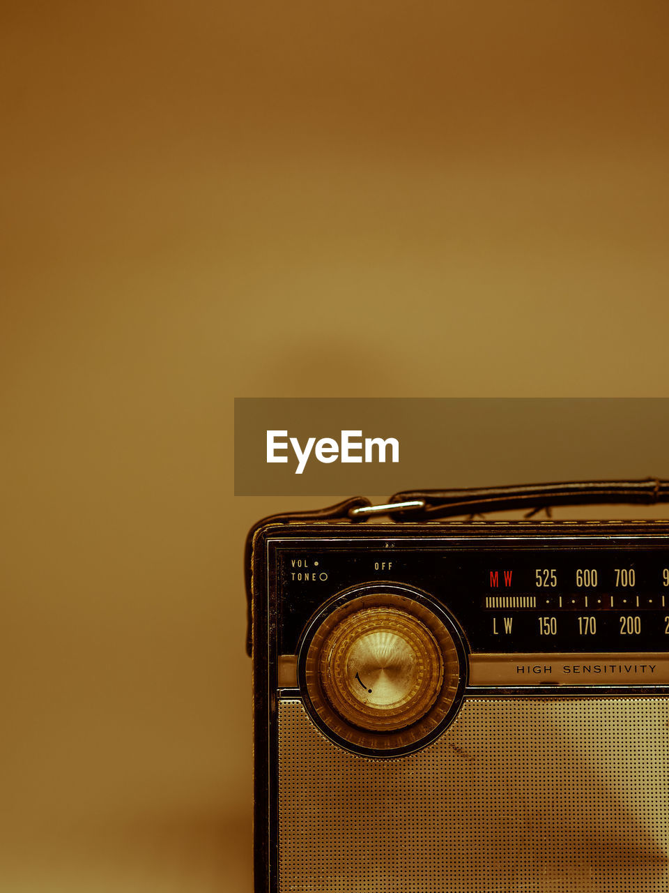 Vintage transistor radio with dial close up with brown background