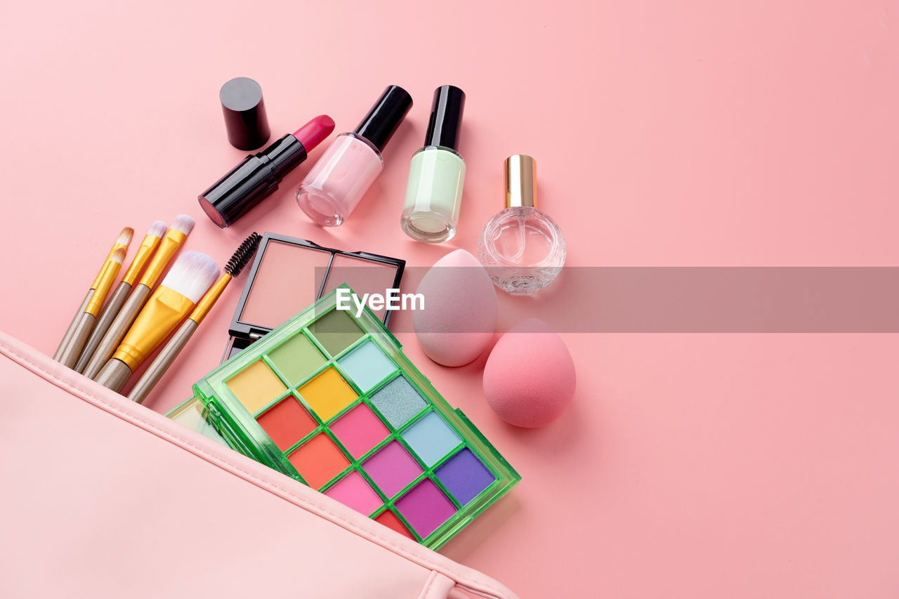 high angle view of beauty products against pink background