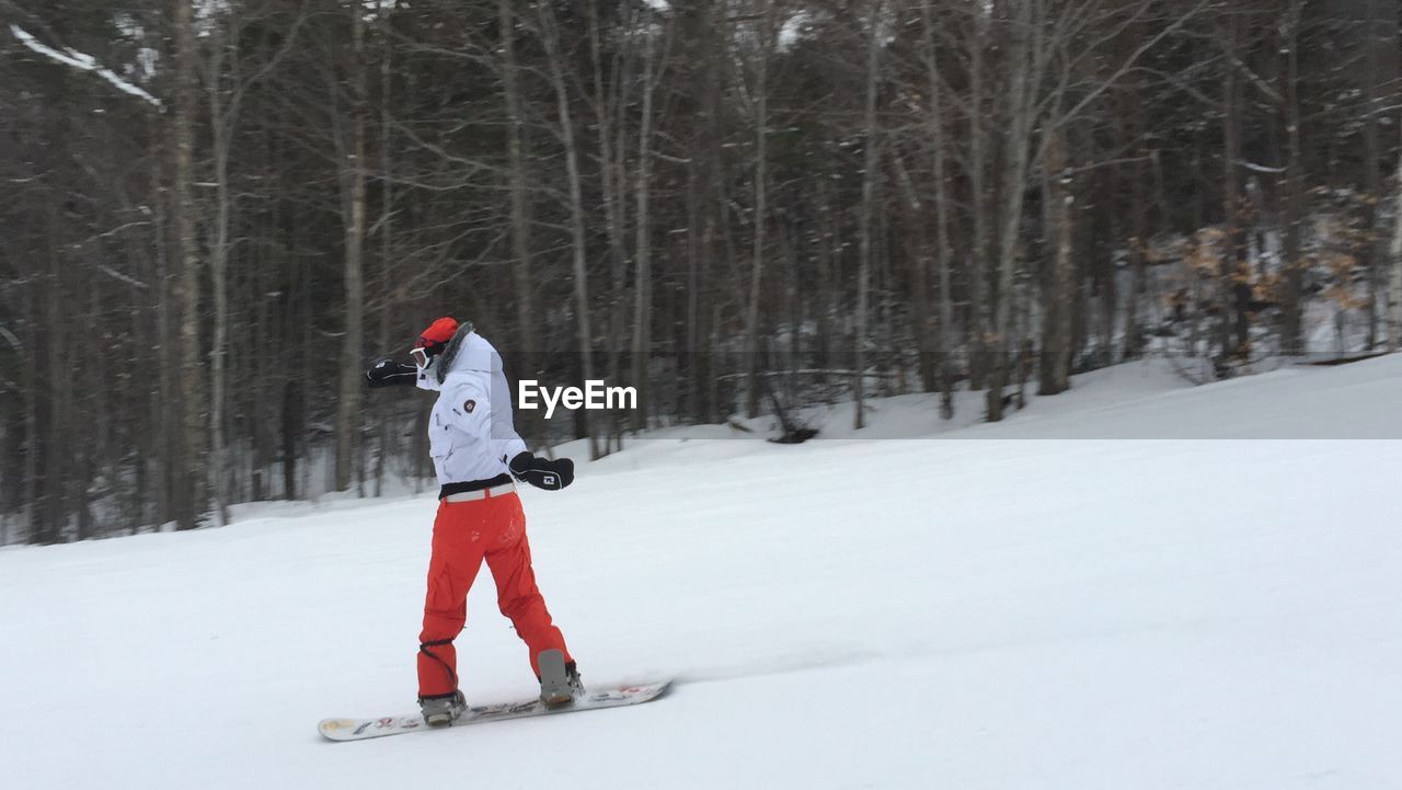 Man snowboarding on snow
