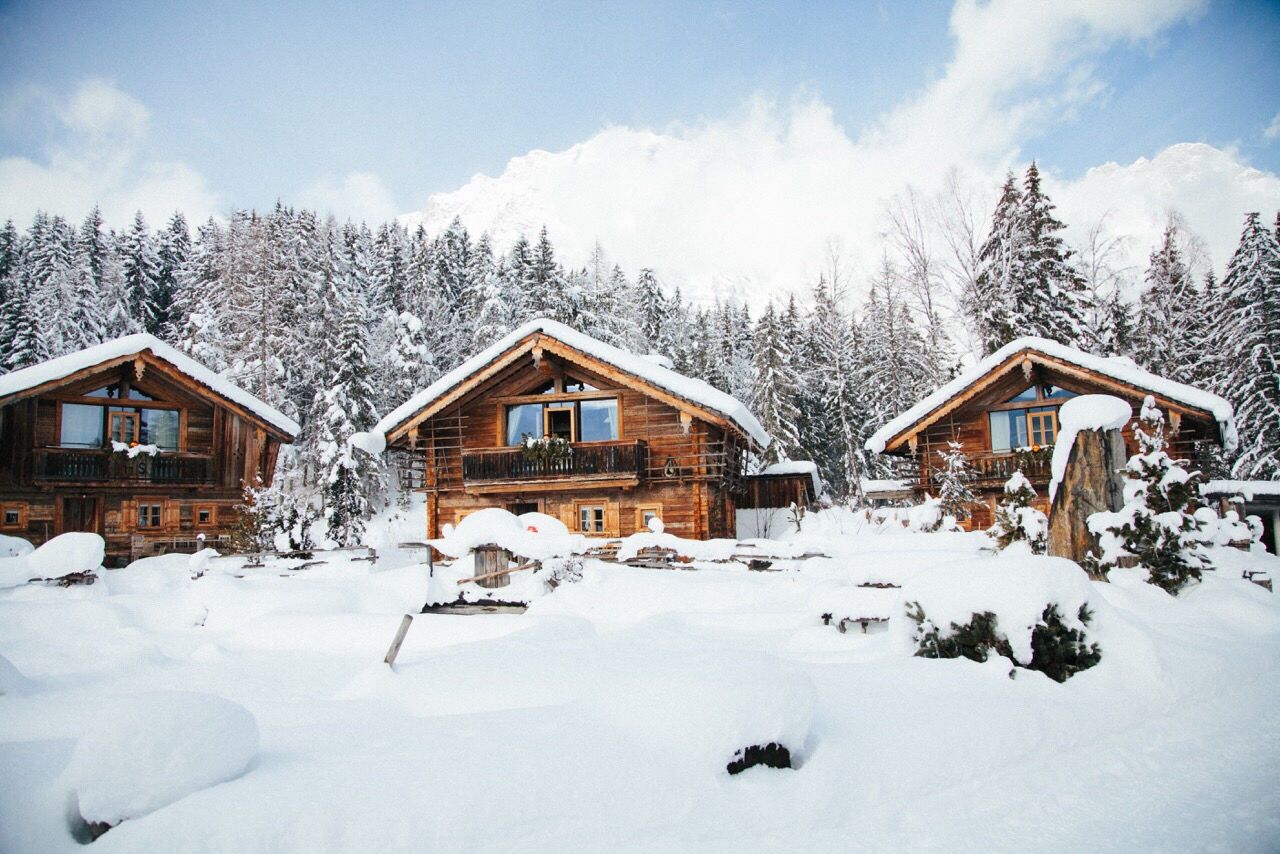 Houses on snow covered landscape against sky