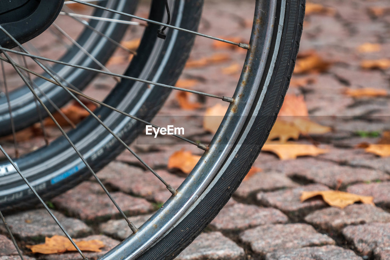 Close-up of bicycle wheels on street